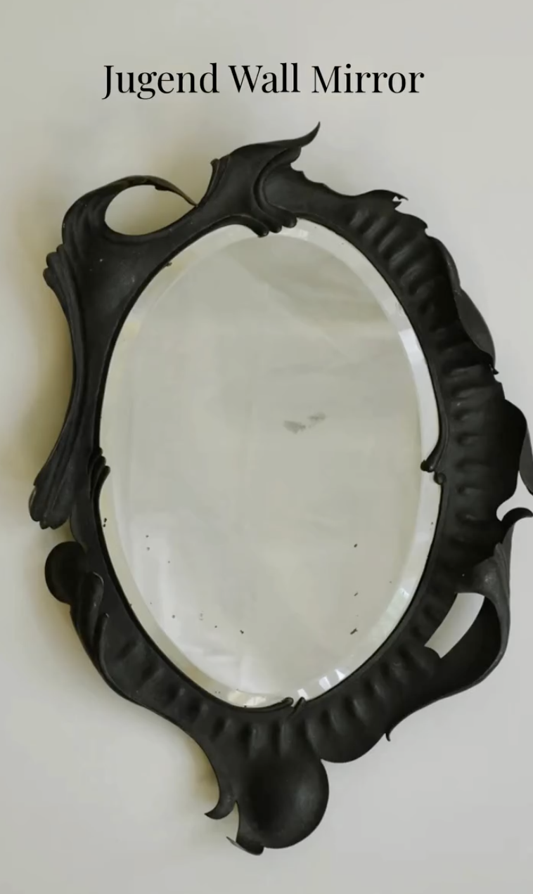 2. Dark Jugend-style wall mirror with an oval glass