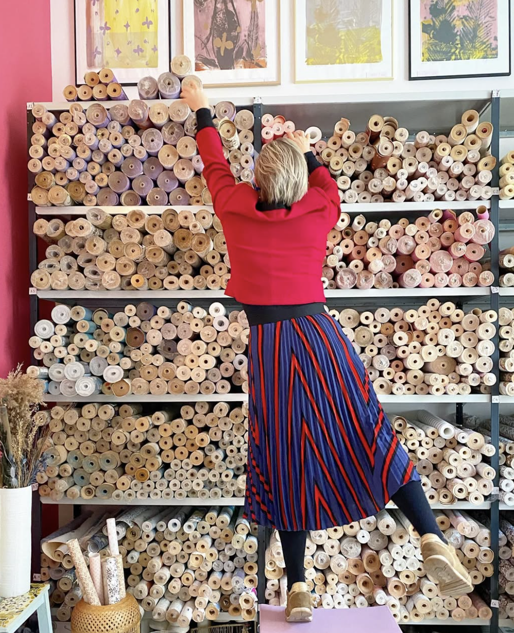 Browsing rolls of vintage wallpaper in a shop Retro Villa
