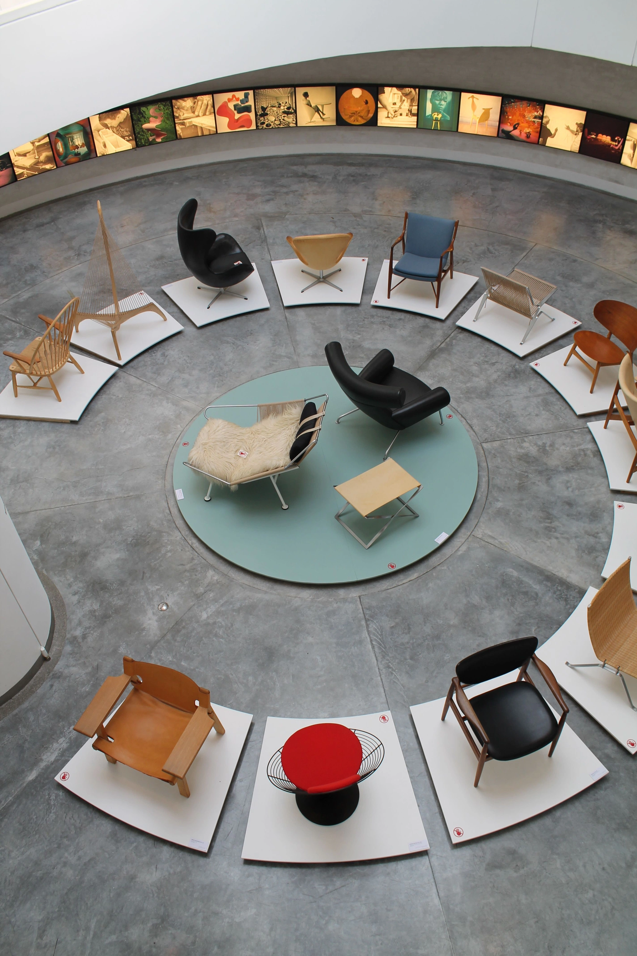 Circular showroom display of Danish design classics on plinths. Photo: Pinterest